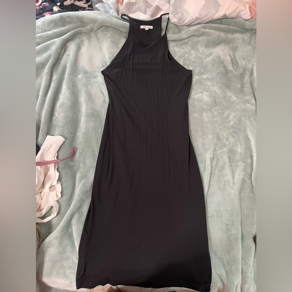 Black knee length sleeveless dress.